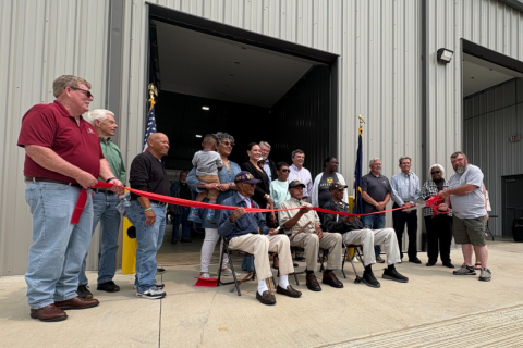 photograph of a group of residents from Paris' Westside neighborhood and local officials at the ribbon cutting for the newly opened transfer station